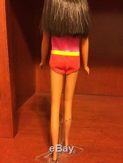 Vintage doll from 1966 wearing malibu francie swimsuit and glasses